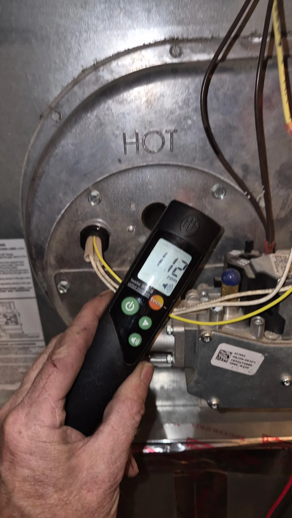 Denver HVAC technician testing furnace combustion with analyzer